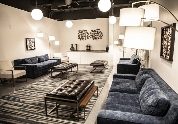 Kaqun LA guest lounge with velvet sofas, glass coffee tables and globe pendant lights