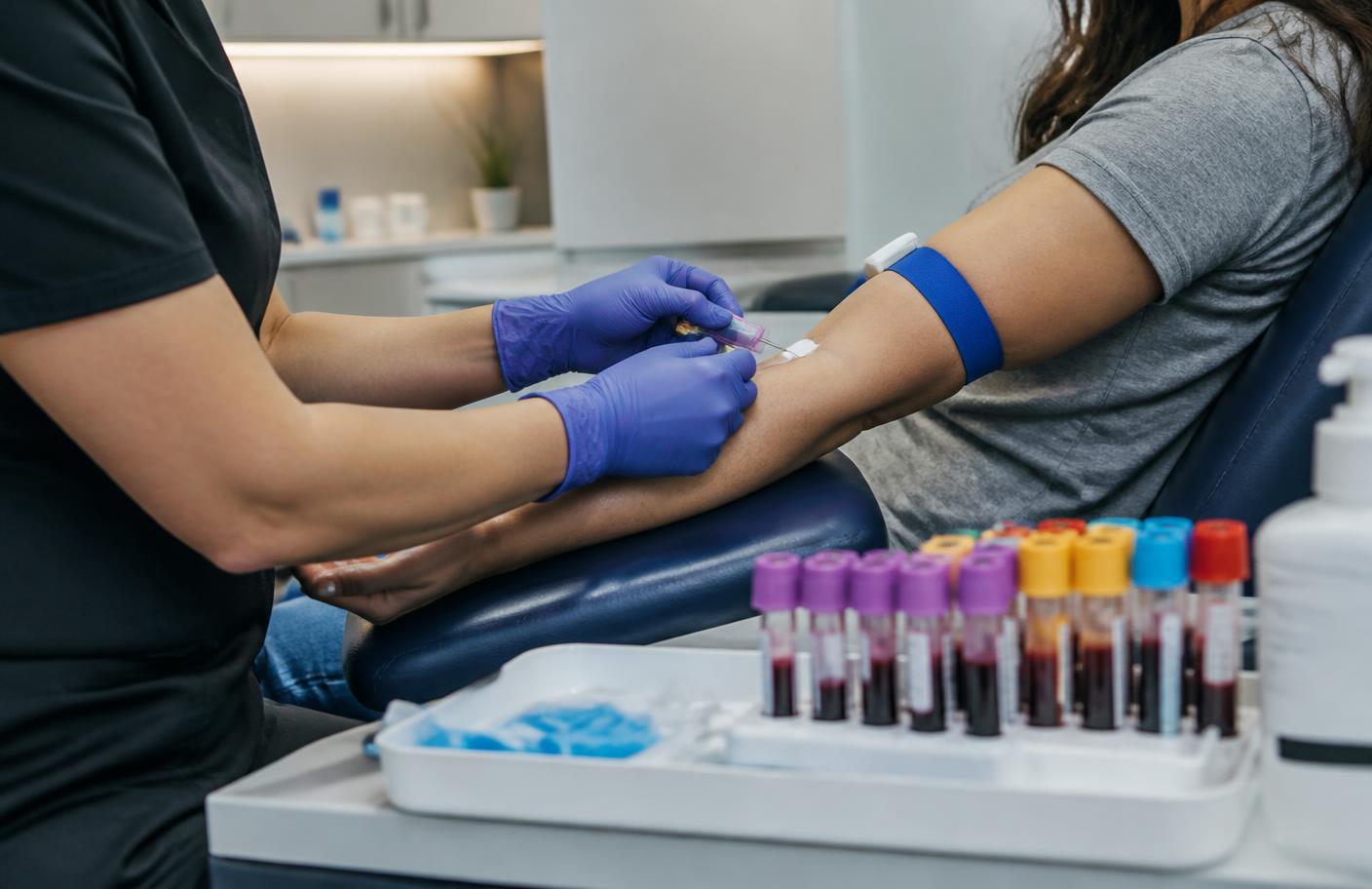 Phlebotomist collecting labeled tubes for a comprehensive Kure Health lab panel in the Downtown Los Angeles clinic