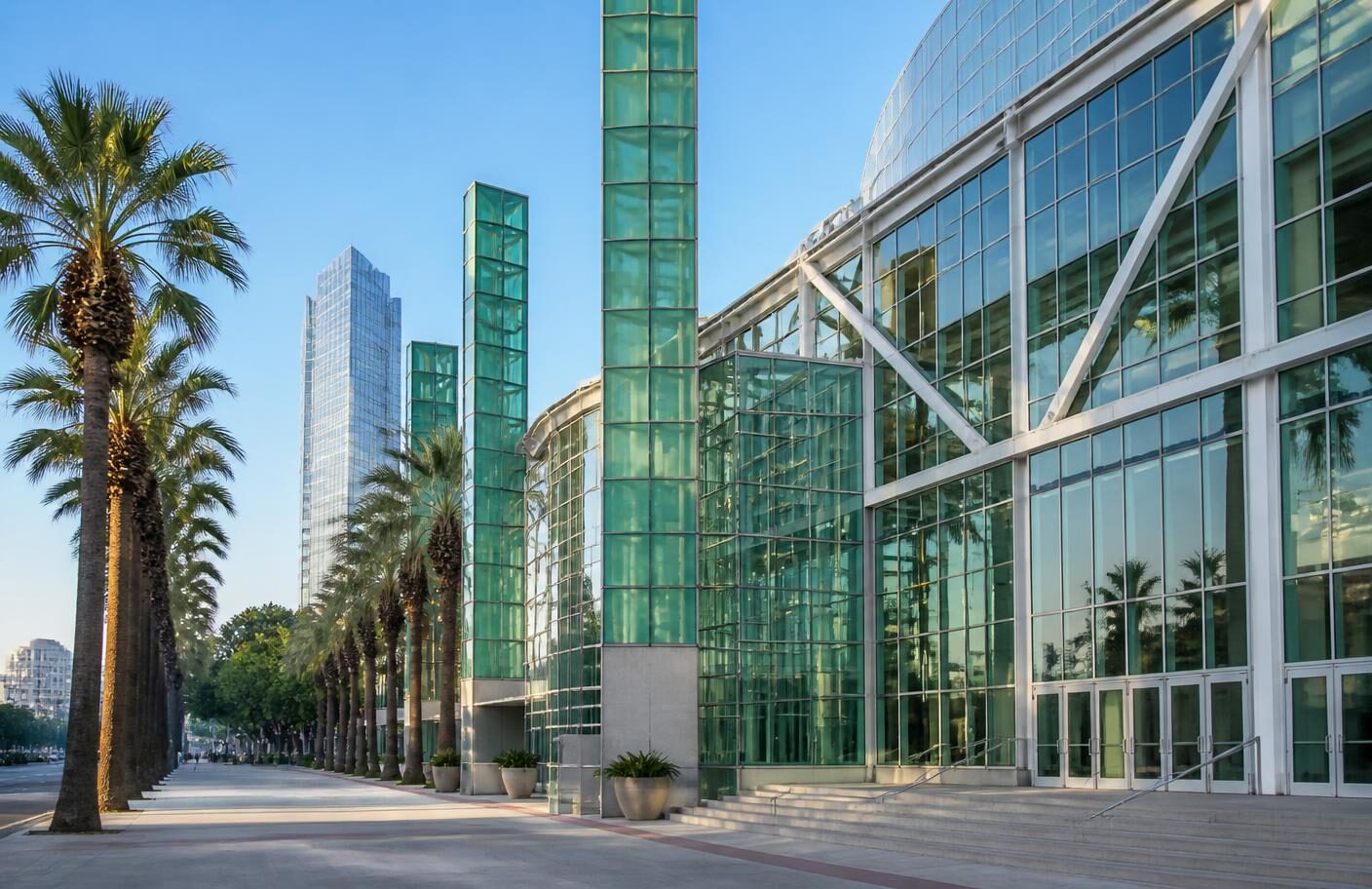 Green glass facade of the Los Angeles convention center on a bright morning, the conference and trade show venue near the Kure Health corporate block