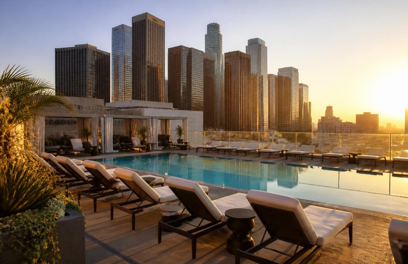 Rooftop pool terrace at sunset above Downtown Los Angeles, the amenity level guests expect from properties referring to Kure Health